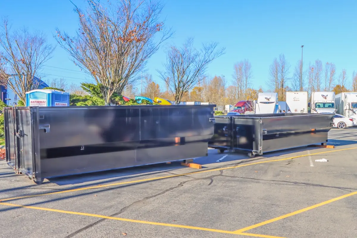 Professional dumpster rental service with roll-off container on residential driveway in Milan